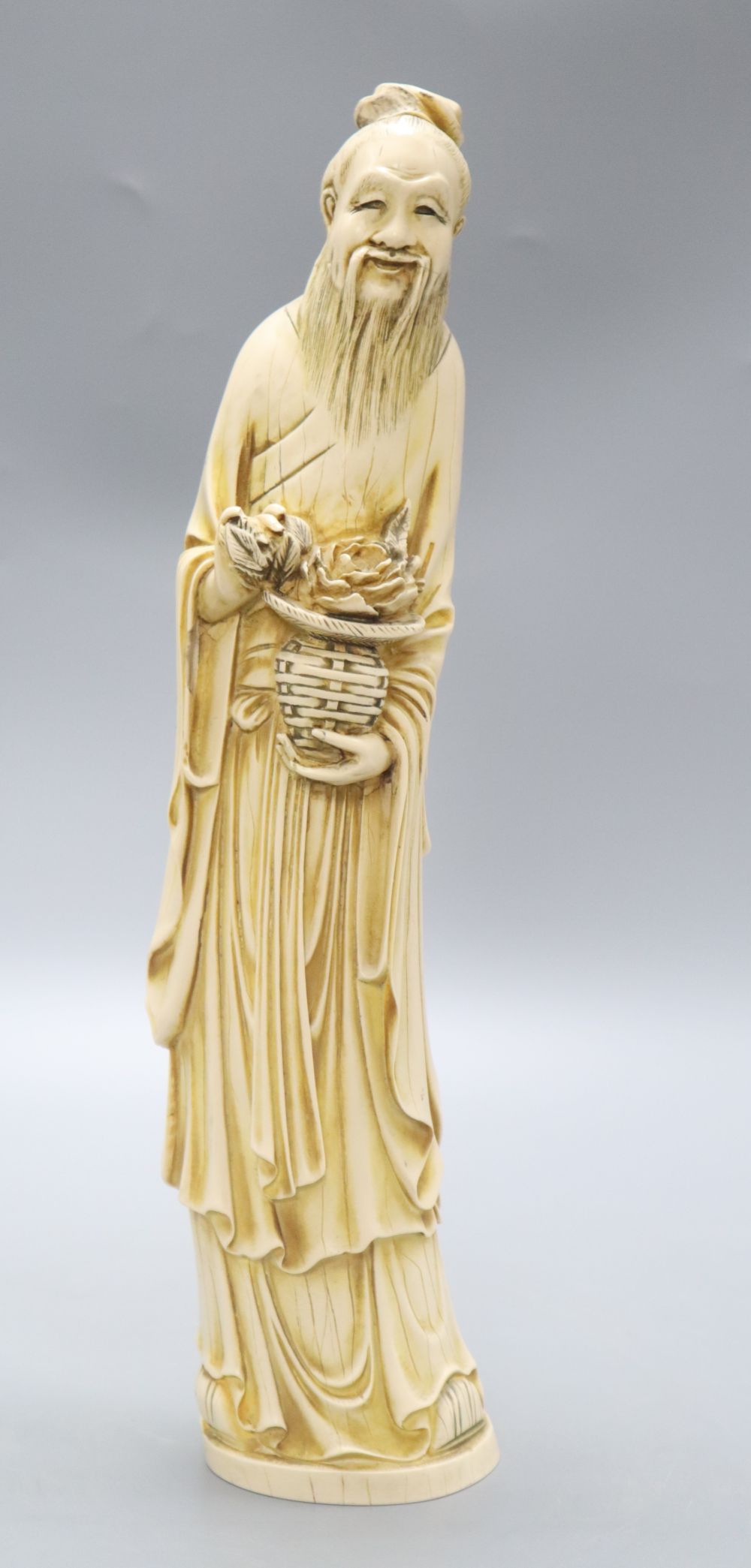 A Chinese simulated ivory figure of an elder, height 37cm